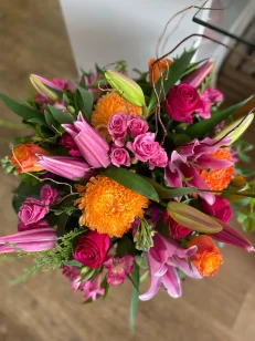 Large Emerson Flower bouquet featuring elegant orange, pink and red flowers and mini roses.